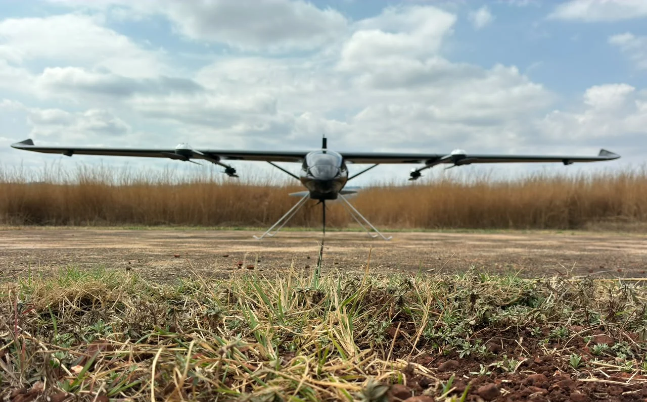 Sky Robots VTOL aircraft photographed head-on at a field site