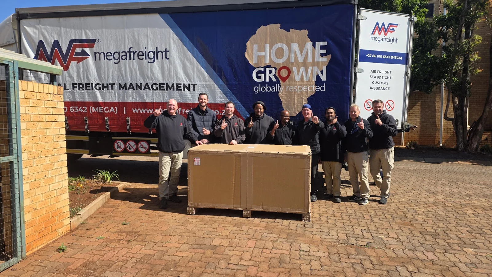 Sky Robots team beside crated equipment for the first Nigeria shipment